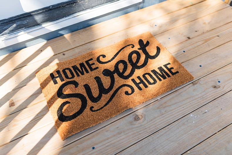 A "Home Sweet Home" welcome mat outside of a house in a 55+ community.