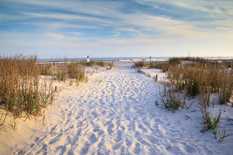 A sandy path with footprints leading to the Atlantic Ocean on Folly Beach near Charleston, South Carolina.
