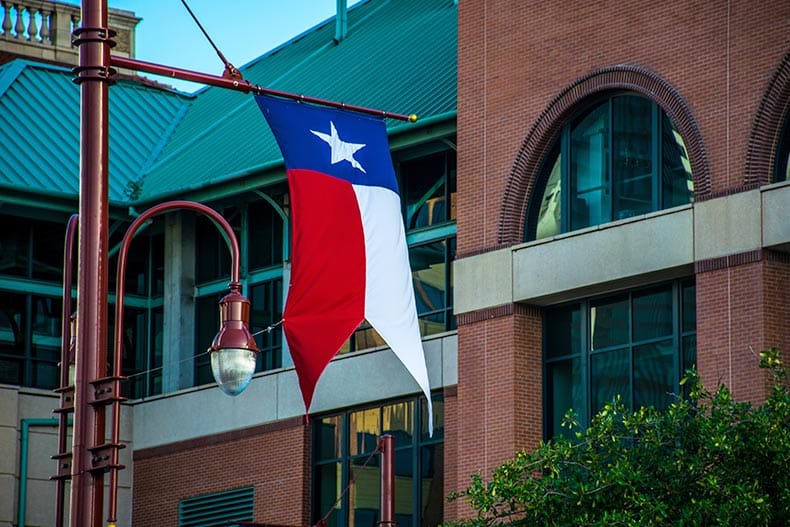 The Texas Flag waves in the wind in Downtown Houston, Texas, a good place to retire.