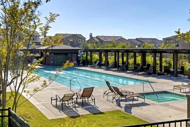 Lounge chairs beside the outdoor pool at Auberge at Del Sur, one of many luxury retirement communities in San Diego.