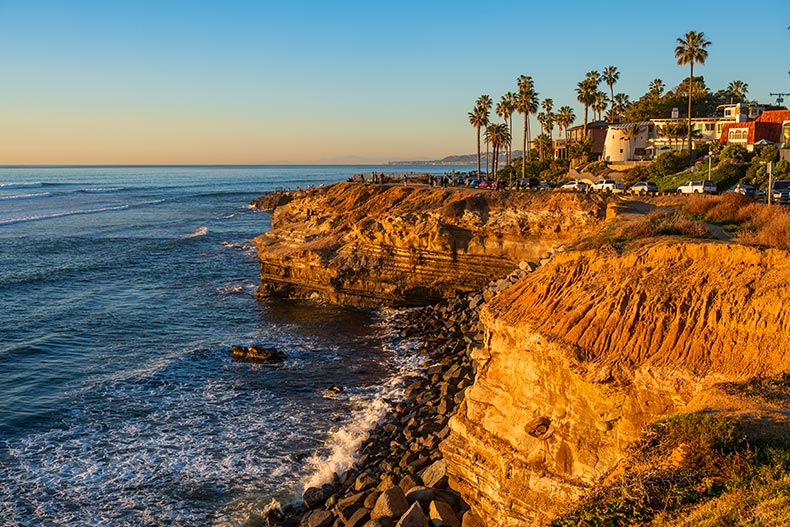 Sunset view of cliffs beside the ocean in San Diego, California.