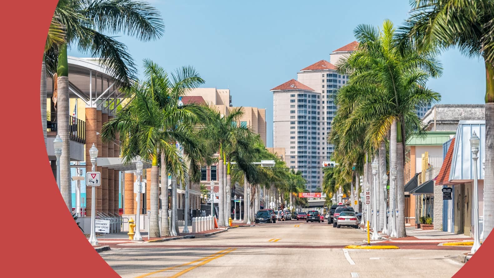 A street in downtown Fort Myers, Florida lined with palm trees.