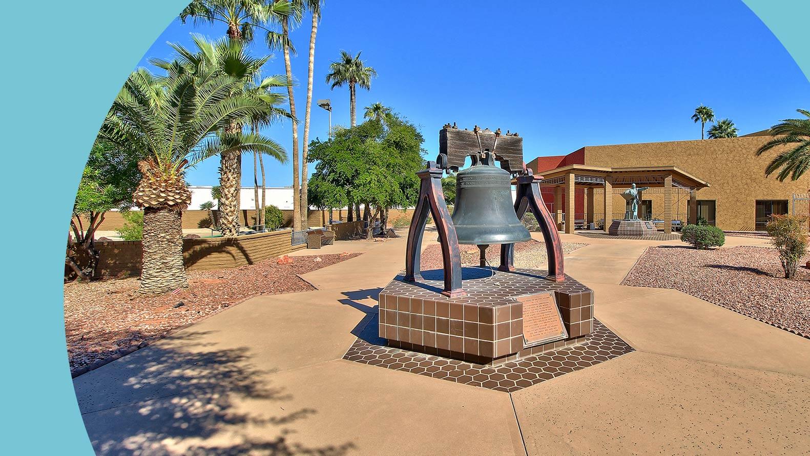 A bell in the center of a courtyard and walkway in Sun City.