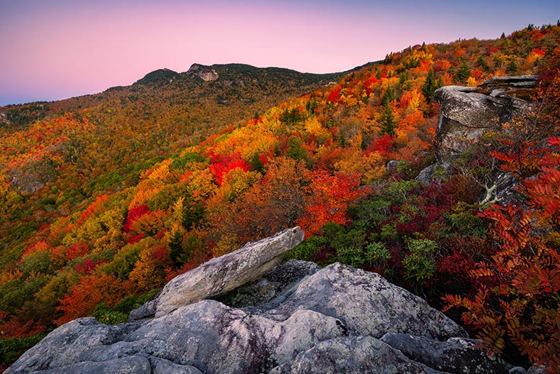 Peak autumn foliage and soft predawn light over the Blue Ridge Mountains of North Carolina, one of the best states to retire.
