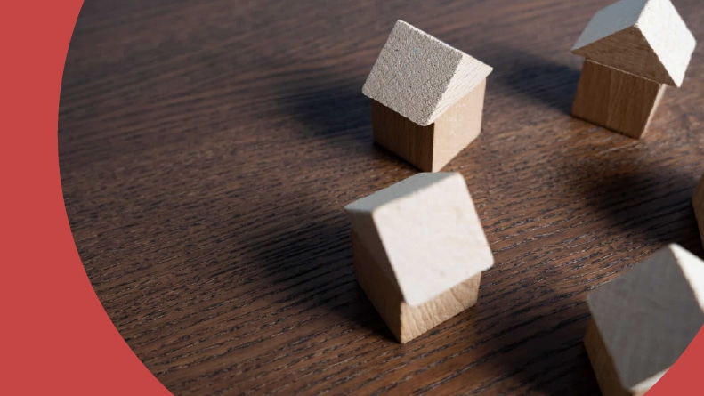 A circle of small, wooden house figures.