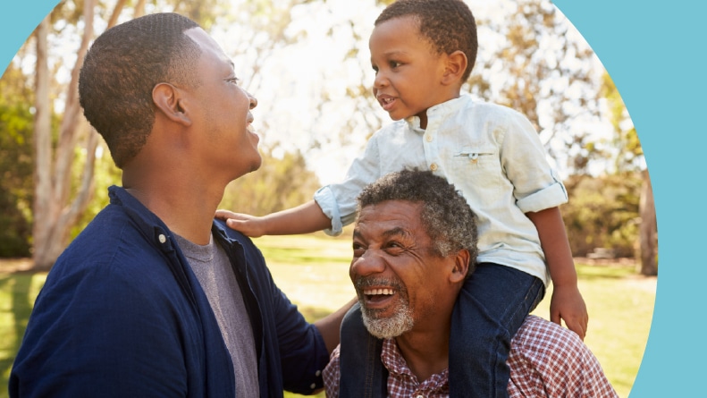 A grandfather with his son and grandson having fun in a park.