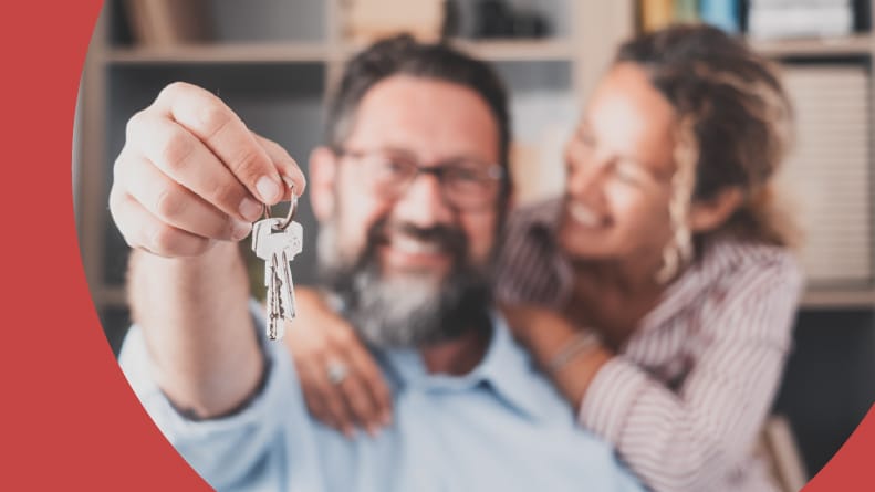 Focus on house keys held by excited homeowners who successfully navigated the real estate market.
