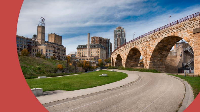 A bike path beside the Stone Arch Bridge in Minneapolis, Minnesota, one of the best places to retire for bicycle riding.