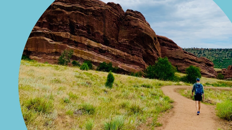 A man walking on a trail in Red Rocks Park near Denver, Colorado.