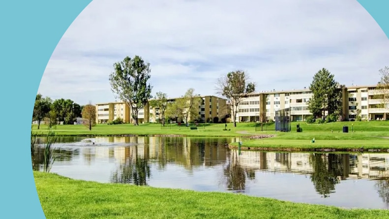 View across a pond of the residential buildings at Windsor Gardens in Denver, Colorado.