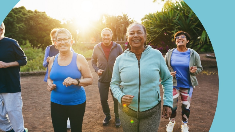 A group of older friends working out together in their 55+ community.