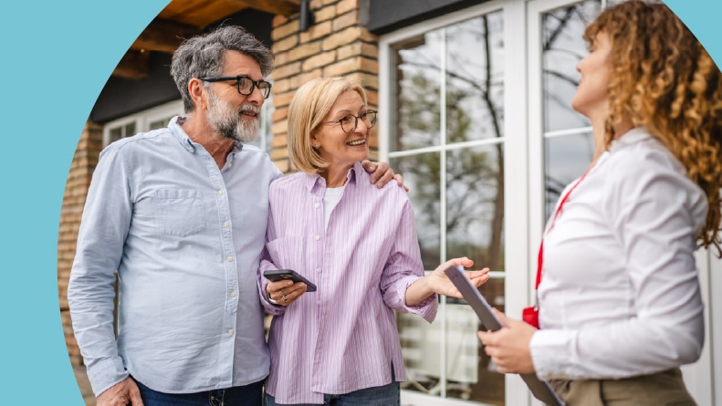 A 55+ couple meeting with a real estate agent.
