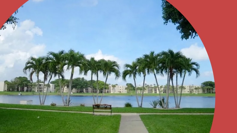 Palm trees beside a pond on the grounds of Las Verdes in Delray Beach, Florida.