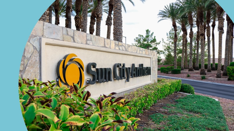 Palm trees surrounding the community sign at Sun City Anthem in Henderson, Nevada.