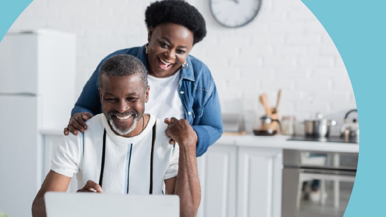 A 55+ couple talking with their Realtor via a laptop at home.