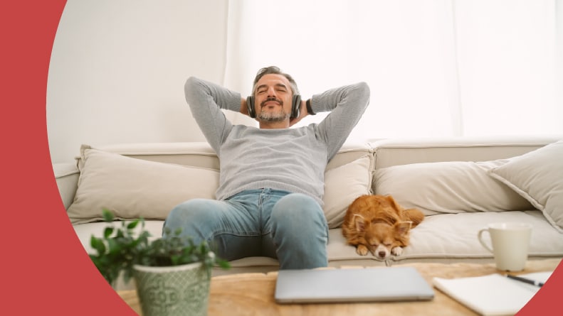 A man relaxing with his dog in his 55+ apartment.