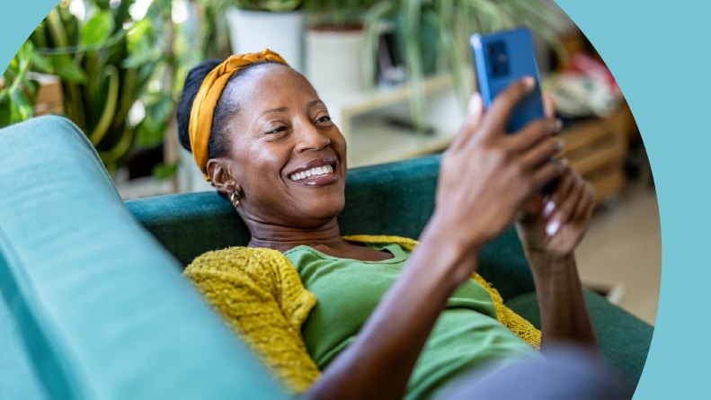 A woman browsing 55+ apartment listings on her phone.