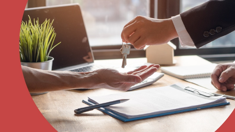 A Realtor agent handing over the keys to a home in a 55+ community.