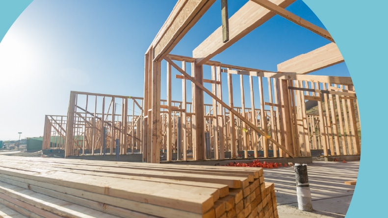The wooden frames of new houses at a construction site.