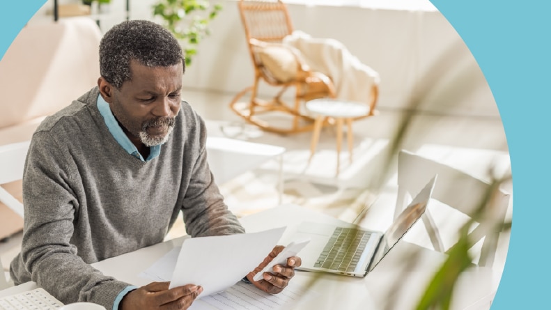 A retired man looking at his housing bills in a 55+ community.