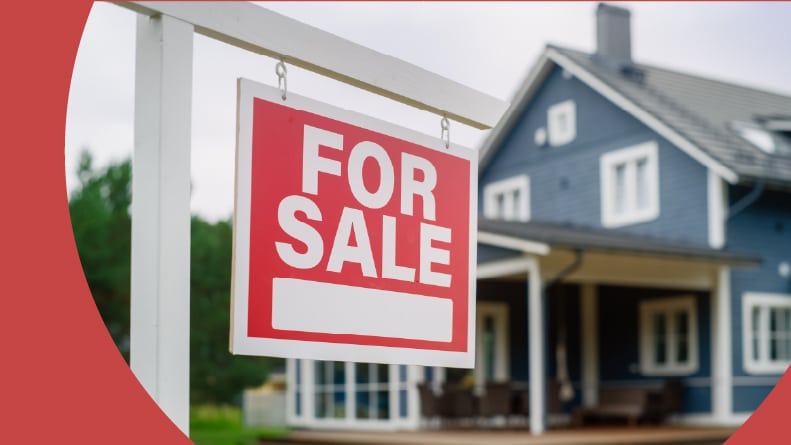 A red "For Sale" sign in the yard of a resale home.