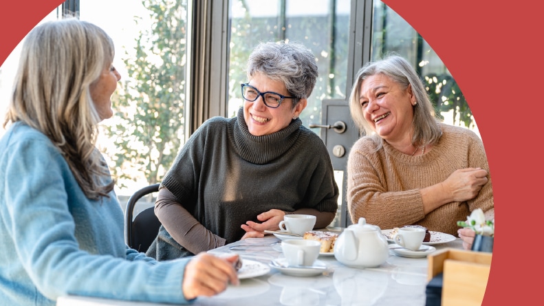 Three retired female friends drinking tea and coffee and eating cake in a 55+ community.