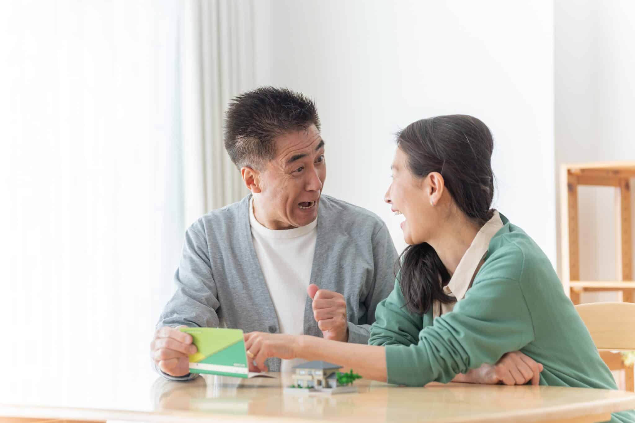 Senior couple laughing and playing a game together.