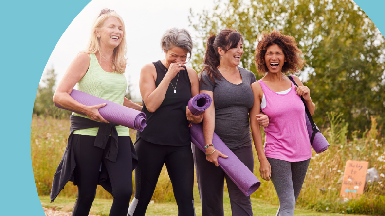 A group of 55+ friends on their way to a yoga class outside.