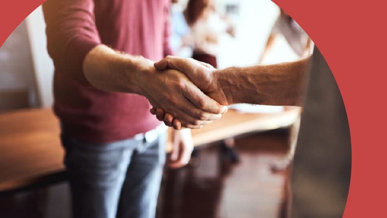 Two 55+ homeowners shaking hands at an HOA meeting.