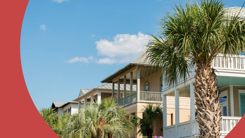 Row of houses with balconies with palm trees view at the front in Destin, Florida.