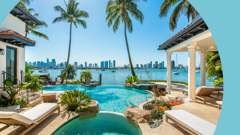 Palm trees and lounge chairs beside a pool in Miami Beach.