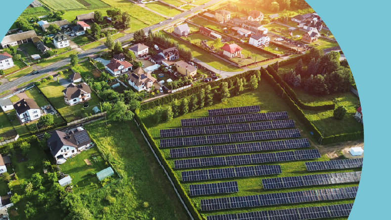 Aerial view of a green neighborhoods with solar-powered homes.