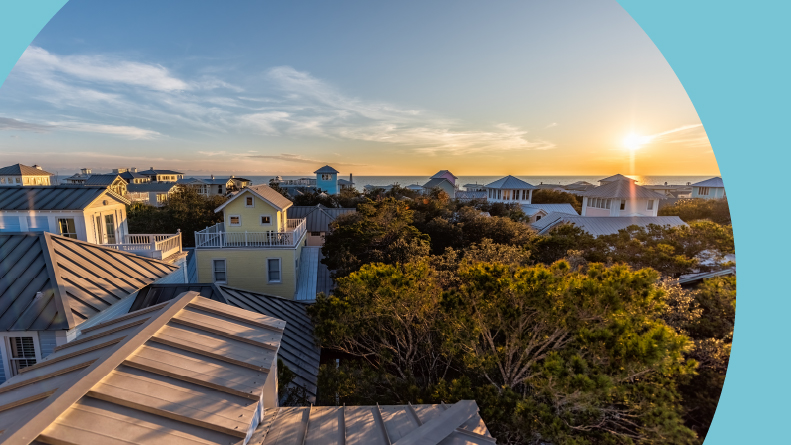 A sunset over the ocean landscape and homes in Seaside, Florida.