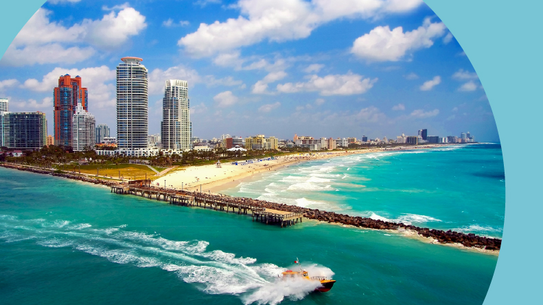 Aerial view of South Miami Beach with a boat sailing next to the shore.