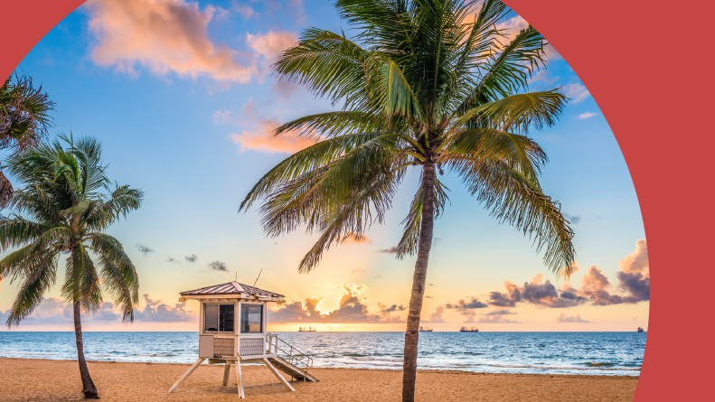 A lifeguard tower and palm trees along the beach in Fort Lauderdale, Florida.