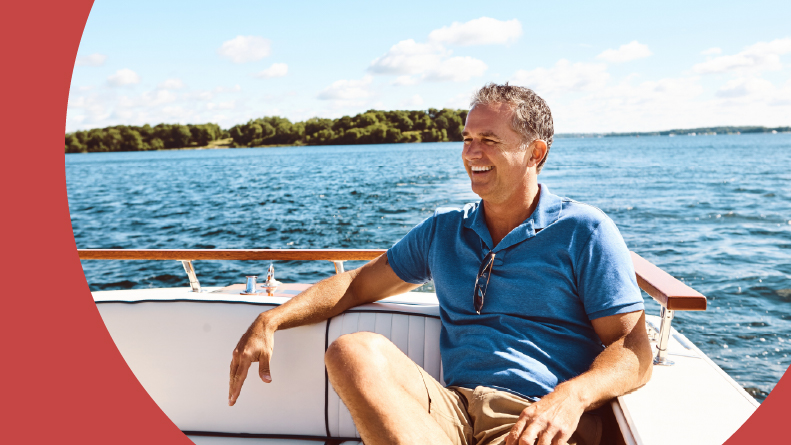 A smiling 55+ man in a boat in Florida.
