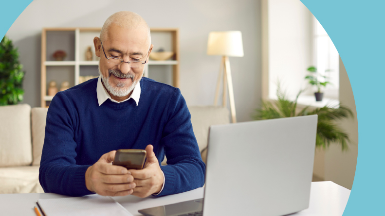 A 55+ man looking over his retirement accounts on a laptop at home.