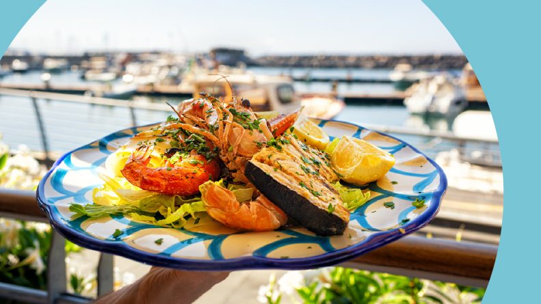 Serving a seafood and fish lunch at a seaside restaurant.