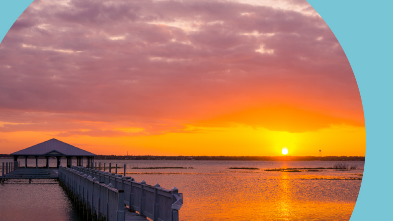 A sunset over the pier on Lake Jackson in Sebring, Florida.