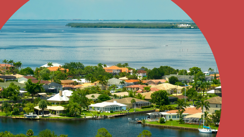 Aerial view of private homes on the Gulf Coast near wildlife wetlands and the shore.
