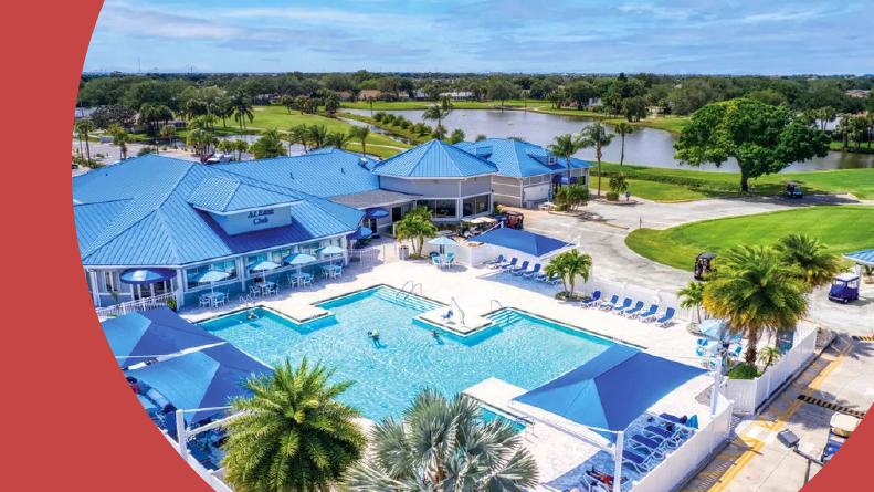 Aerial view of the clubhouse and resort-style pool at Indian River Colony Club in Melbourne, Florida.