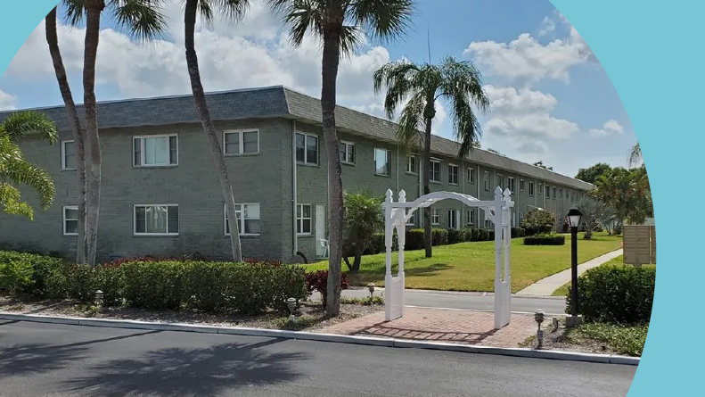 Condo buildings on the grounds of Paradise Shores, one of many 55+ communities in Florida with low HOA fees.