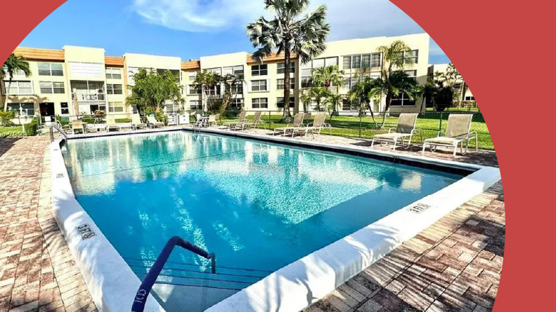 Lounge chairs beside the outdoor pool at Royal Park Gardens in Margate, Florida.