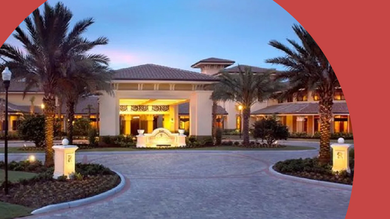 Palm tree surrounding the entrance to the clubhouse at night at Sun City Center in Sun City Center, Florida.