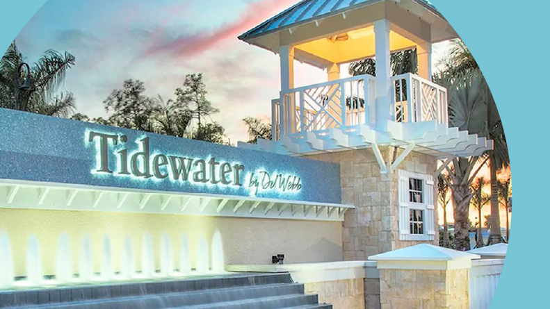 The community sign and water feature at the entrance of Tidewater by Del Webb in Estero, Florida.