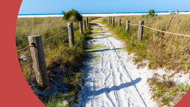 A trail leading to the white sand of Siesta Key Beach in Florida.