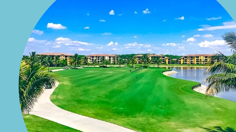 Aerial view of the golf course surrounded by residential buildings at Bonita National Golf & Country Club in Bonita Springs, Florida.