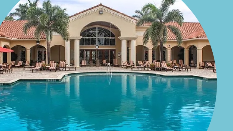 Lounge chairs beside the outdoor pool at Cascade Lakes in Boynton Beach, Florida.