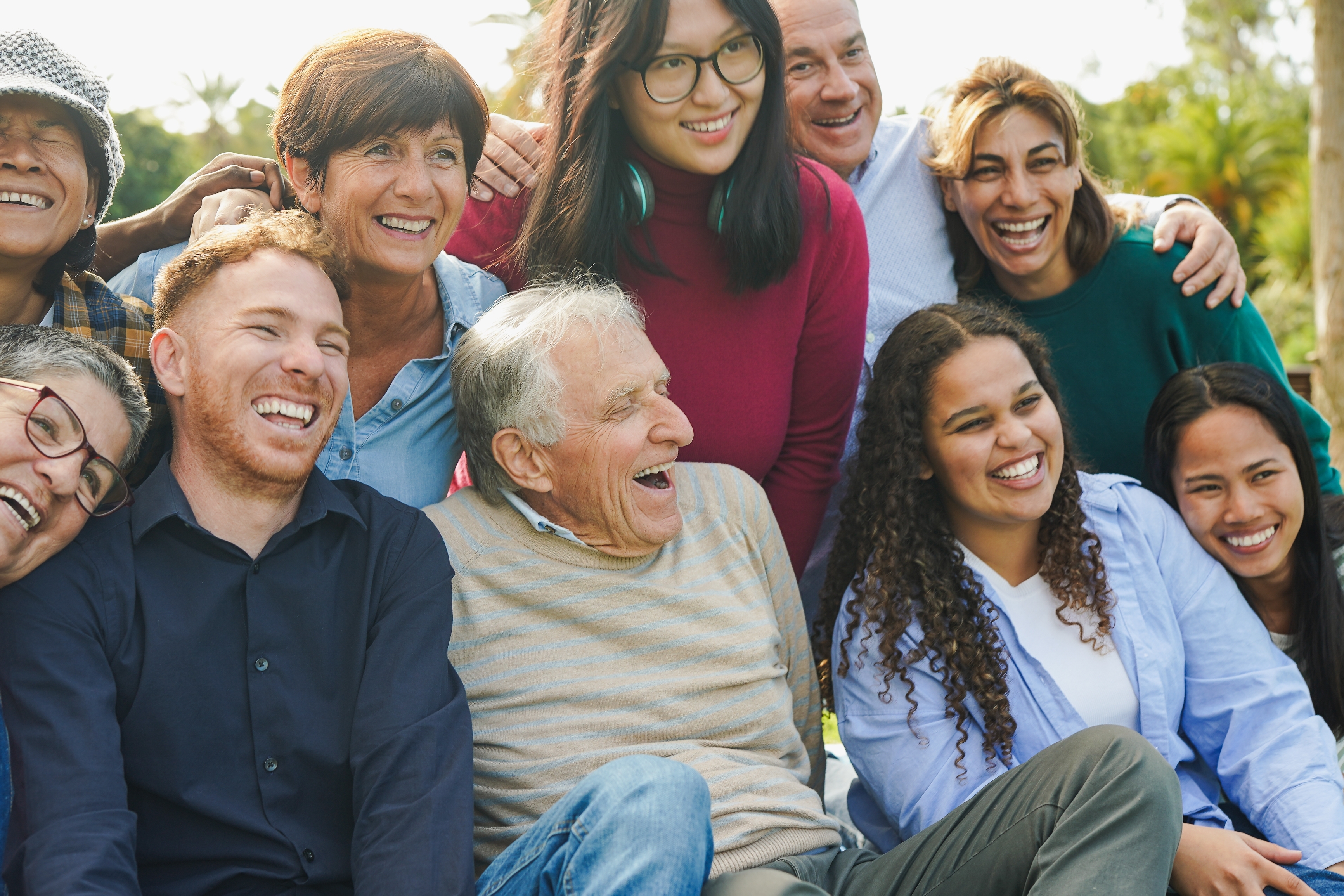 Multi-generational people having fun together at a community park.