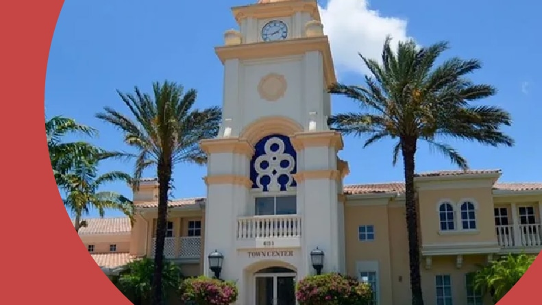 Palm trees beside the entrance to the clubhouse at Island Walk in Naples, Florida.